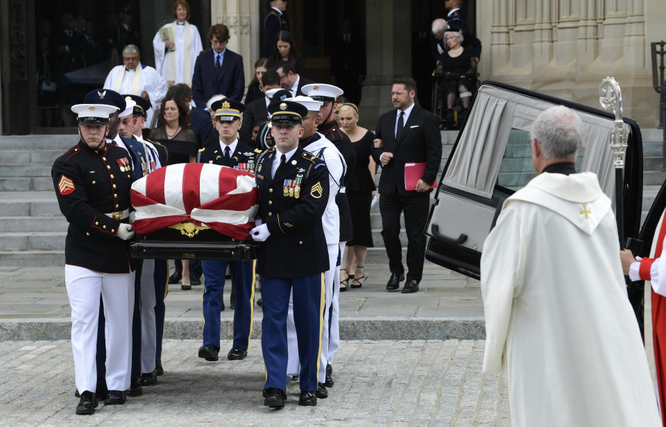 The casket of Sen. John McCain, R-Ariz., followed by family members, is carried out of Washington National Cathedral in Washington , Saturday, Sept. 1, 2018, following a memorial service. McCain died Aug. 25 from brain cancer at age 81. (AP Photo/Susan Walsh)