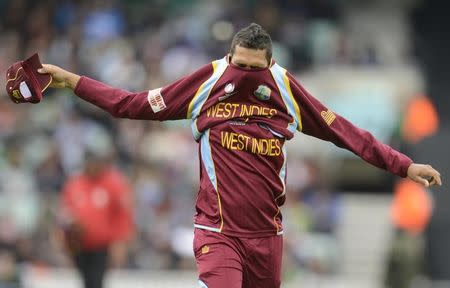 West Indies' Sunil Narine puts on a top during their ICC Champions Trophy Group B match against India at The Oval cricket ground in London June 11, 2013. REUTERS/Philip Brown