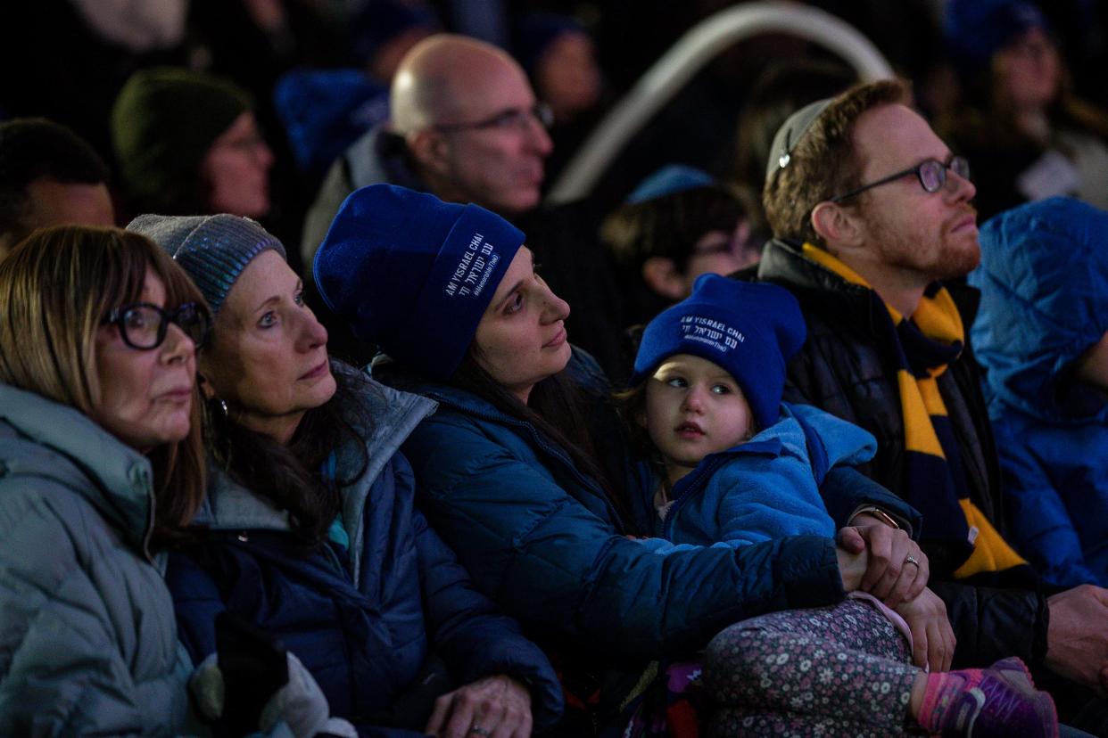 People listen to Rabbi Kasriel Shemtov speak during the annual Menorah in the D at Campus Martius in Detroit on Thursday, Dec. 7, 2023.