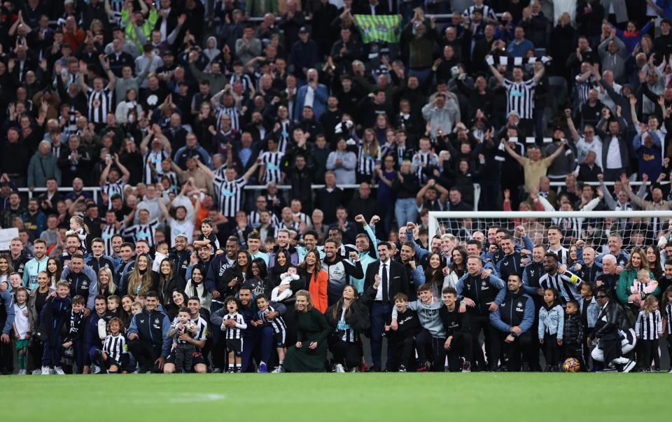 Players, staff and families of Newcastle United pose for a photo - Alex Livesey/Getty Images