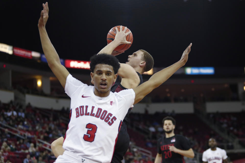 San Diego State's Malachi Flynn drives to the basket as he's guarded by Fresno State's Jarred Hyder during the second half of an NCAA college basketball game in Fresno, Calif., Tuesday Jan. 14, 2020. (AP Photo/Gary Kazanjian)