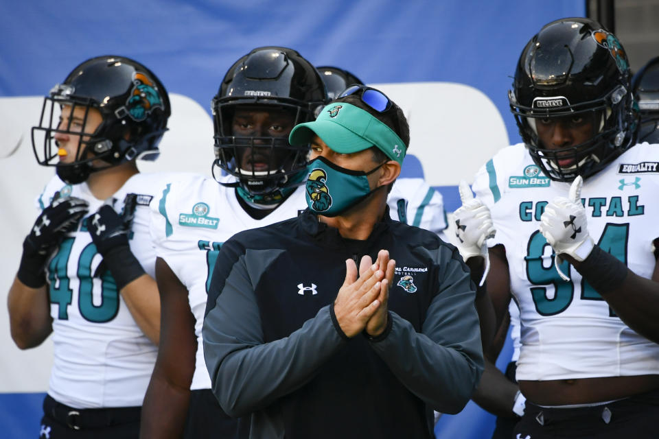 FILE - In this Oct. 31, 2020, file photo, Coastal Carolina coach Jamey Chadwell waits to lead his team onto the field for an NCAA football game against Georgia State in Atlanta. Chadwell is The Associated Press college football coach of the year after leading the Chanticleers to a surprising near-perfect season. Chadwell received 16 first-place votes and 88 points from the AP Top 25 panel to finish ahead of Indiana’s Tom Allen, who was second with 14 first-place votes and 66 points. (AP Photo/John Amis, File)