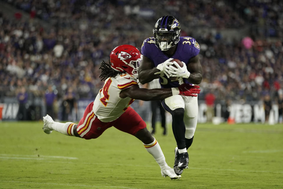 Baltimore Ravens running back Ty'Son Williams (34) rushes past Kansas City Chiefs linebacker Nick Bolton in the first half of an NFL football game, Sunday, Sept. 19, 2021, in Baltimore. (AP Photo/Julio Cortez)