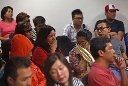 Family of passengers onboard missing AirAsia flight QZ8501 react at a waiting area in Juanda International Airport, Surabaya December 28, 2014. REUTERS/Beawiharta