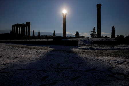 The sun rises behind the ancient Temple of Zeus following a snowfall in Athens, Greece, January 8, 2019. REUTERS/Alkis Konstantinidis