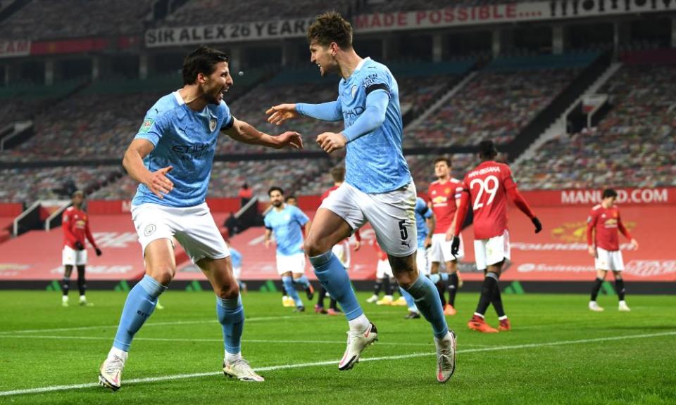 John Stones celebrates with Rúben Dias after scoring in the Carabao Cup semi-final against Manchester United