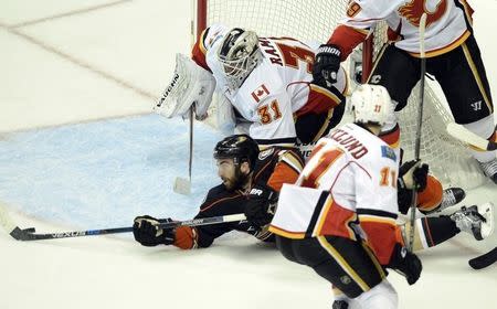 Anaheim Ducks center Andrew Cogliano (front) dives the the puck as he attempts a shot on Calgary Flames goalie Karri Ramo (31) during the third period in game five of the second round of the 2015 Stanley Cup Playoffs at Honda Center, May 10, 2015, Anaheim. Kelvin Kuo-USA TODAY Sports