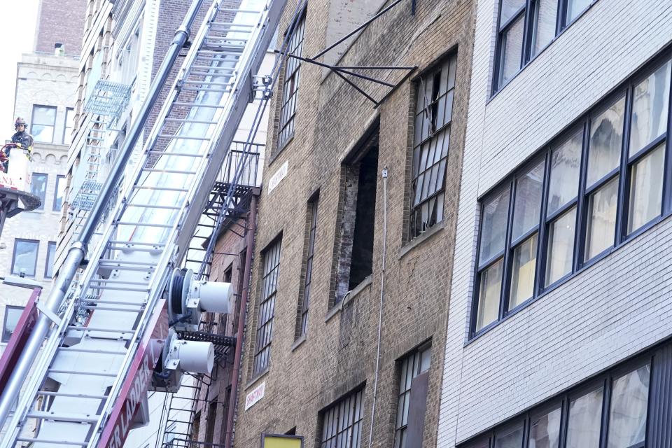 The facade of a partially collapsed parking garage buckles, Tuesday, April 18, 2023, in the Financial District of New York. (AP Photo/Mary Altaffer)