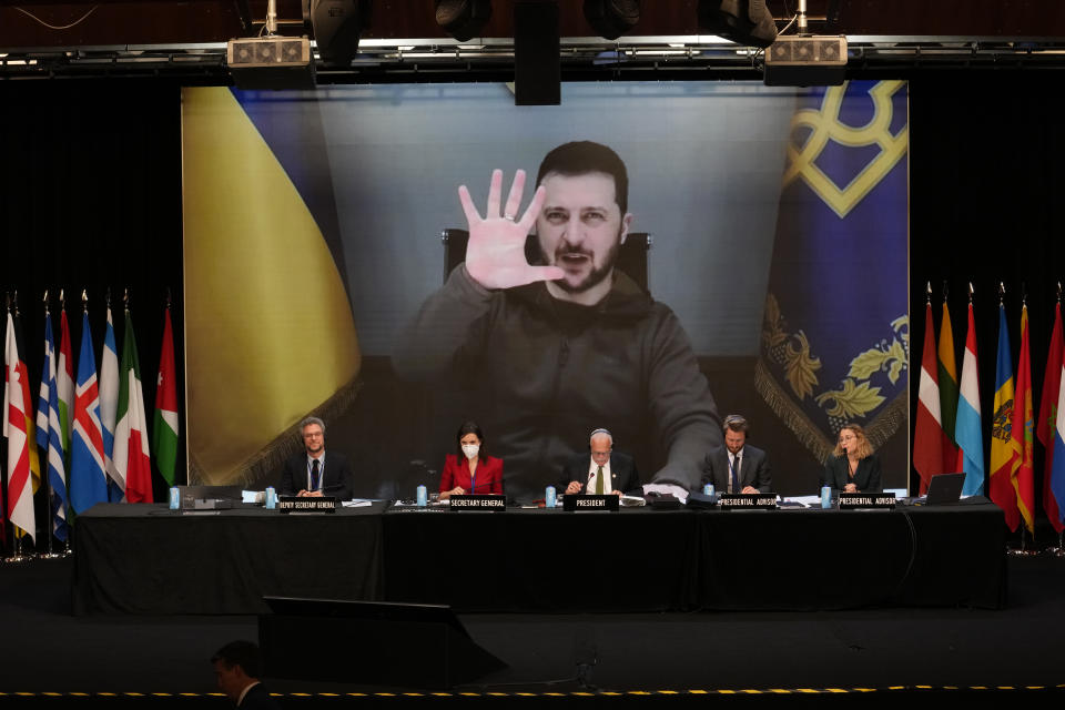 FILE - Ukrainian President Volodymyr Zelenskyy appears on a large screen as he speaks via video conference during the 68th Annual Session of the NATO Parliamentary Assembly in Madrid, Spain, Monday, Nov. 21, 2022. (AP Photo/Andrea Comas, File)