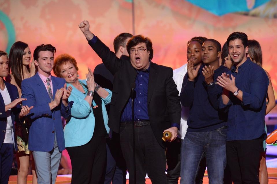 Nickelodeon showrunner Dan Schneider accepting a Kids Choice Award in 2014 alongside stars of “Drake & Josh,” Drake Bell and Josh Peck. FilmMagic