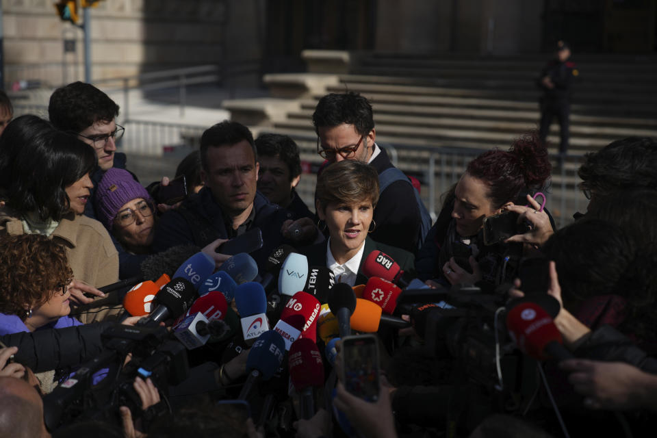 Soccer star Dani Alves' lawyer Ines Guardiola, centre, speaks as she is surrounded by media outside the court in Barcelona, Spain, Thursday, Feb. 22, 2024. Dani Alves has been found guilty of sexually assaulting a young woman in a Barcelona nightclub. A three-judge panel in a Barcelona court sentenced Alves to four years, six months. The 40-year-old Alves denied any wrongdoing during a trial that took place over three days this month. The decision can be appealed. (AP Photo/Emilio Morenatti)