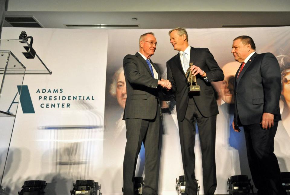 Former Massachusetts Governor Charlie Baker, center, is congratulated by former Joint Chiefs of Staff Chair and Adams Presidential Center Foundation Chair, Retired Marine Corps General Joseph Dunford of Quincy, left, and Quincy Mayor Thomas Koch, right, after being presented with the Adams Award during the Adams Presidential Center fundraiser gala at Granite Links in Quincy, Tuesday, April 11, 2023. Tom Gorman/For The Patriot Ledger 