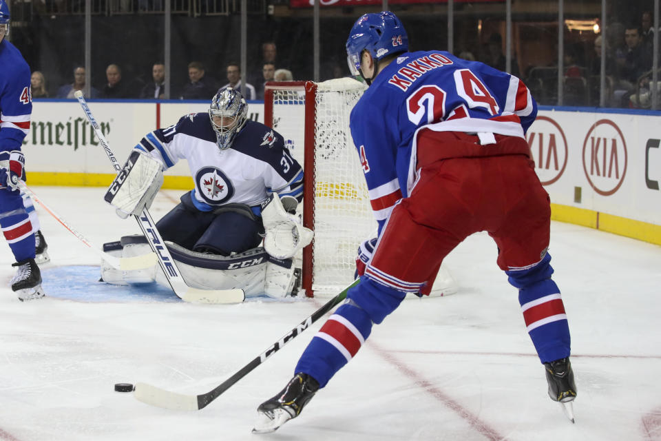 Winnipeg Jets goaltender Connor Hellebuyck (37) watches a shot by New York Rangers right wing Kaapo Kakko (24) before making the save during the second period of an NHL hockey game Thursday, Oct. 3, 2019, at Madison Square Garden in New York. (AP Photo/Mary Altaffer)