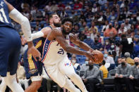 Philadelphia 76ers center Joel Embiid (21) drives to the basket against New Orleans Pelicans center Jonas Valanciunas in the first half of an NBA basketball game in New Orleans, Wednesday, Oct. 20, 2021. (AP Photo/Gerald Herbert)