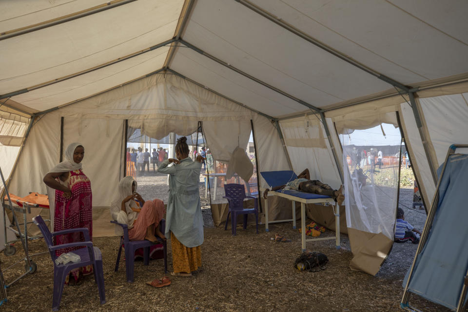 Tigray refugees who fled a conflict in the Ethiopia's Tigray region, wait to receive treatment at a clinic run by MSF (Doctors Without Borders) in Village 8, the transit centre near the Lugdi border crossing, eastern Sudan, Tuesday, Dec. 8, 2020. (AP Photo/Nariman El-Mofty)