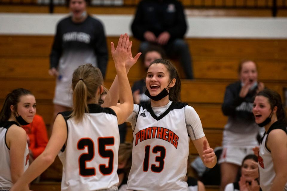 Washington's Georgia Duncan high-fives Alexa Moehle at the start of a home game against Dunlap on Dec. 10, 2021. The Washington Panthers beat the Eagles 48-31.