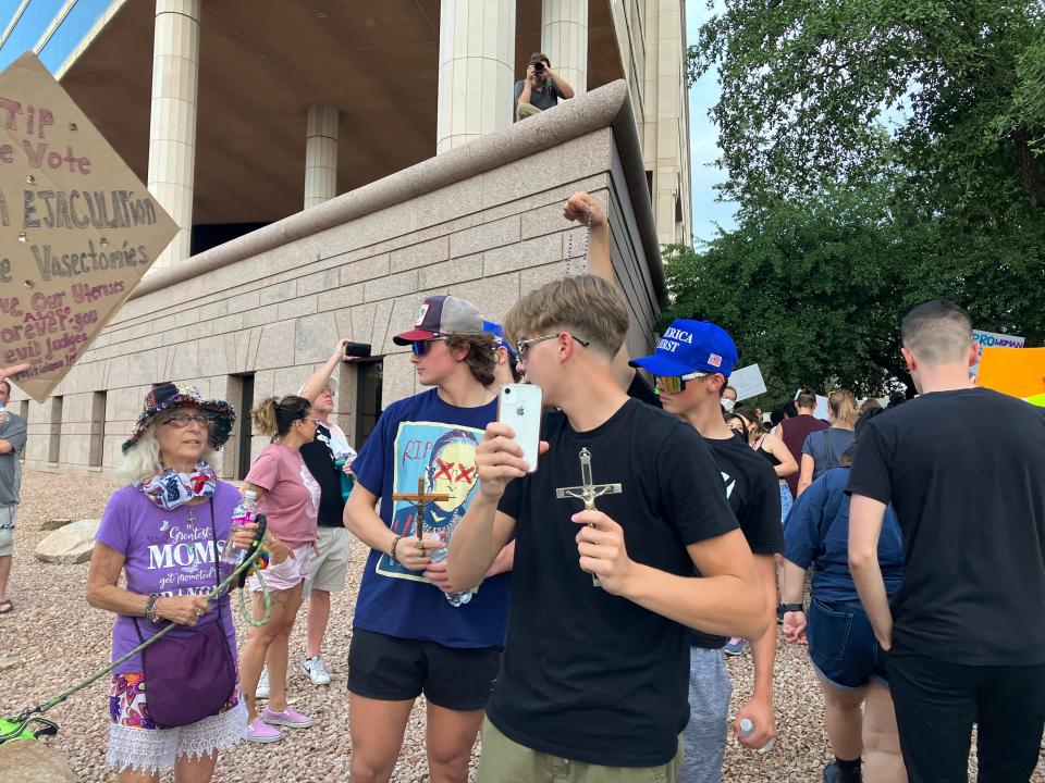 Karina Colbert speaks with anti-abortion rights protesters during the Roe v. Wade march in downtown Phoenix on June 24, 2022.