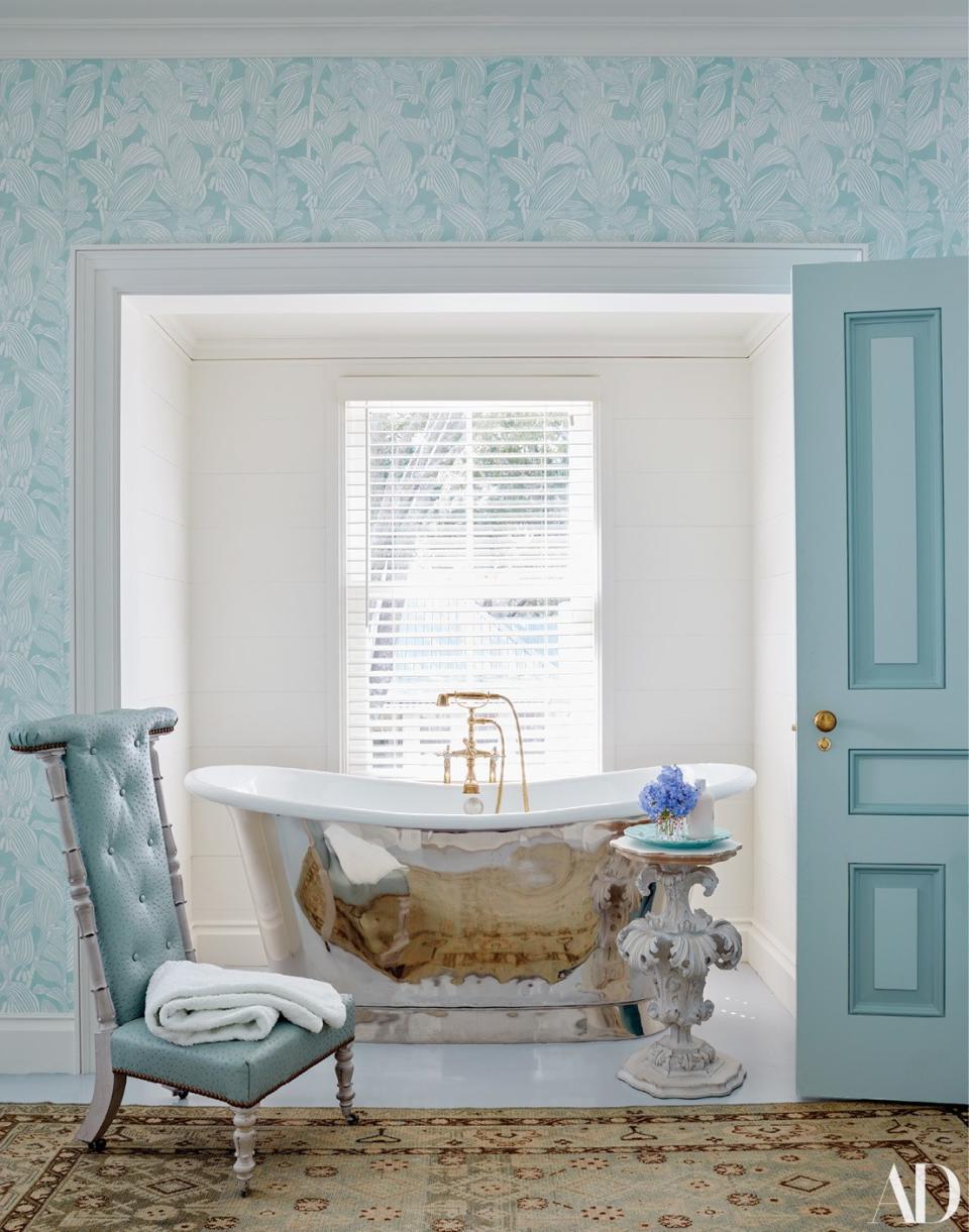 The mater bath features a cast-iron tub by Waterworks. The chair was purchased at auction.