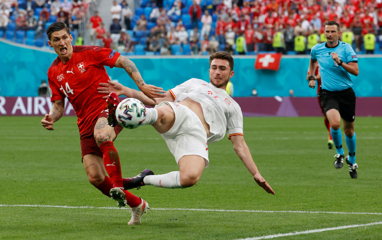 SAINT PETERSBURG, RUSSIA - JULY 02: Aymeric Laporte of Spain clears the ball whilst under pressure from Steven Zuber of Switzerland during the UEFA Euro 2020 Championship Quarter-final match between Switzerland and Spain at Saint Petersburg Stadium on July 02, 2021 in Saint Petersburg, Russia. (Photo by Anatoly Maltsev - Pool/Getty Images)