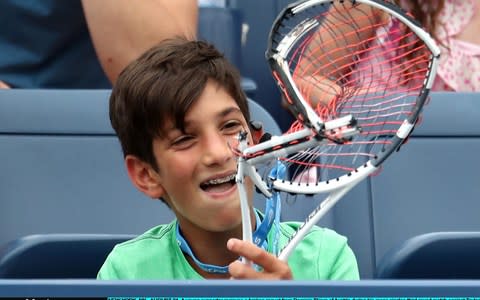 A young supporter recieves a broken raquet from Dominic Thiem of Austria during hie men's singles third round match against Taylor Fritz of the United States on Day Five of the 2018 US Open at the USTA Billie Jean King National Tennis Center on August 31, 2018 in the Flushing neighborhood of the Queens borough of New York City - Credit: Getty images