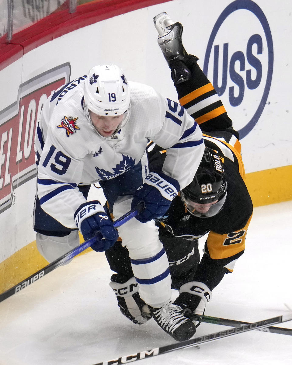 Toronto Maple Leafs' Calle Jarnkrok (19) and Pittsburgh Penguins' Lars Eller (20) collide during the first period of an NHL hockey game in Pittsburgh, Saturday, Nov. 25, 2023. (AP Photo/Gene J. Puskar)