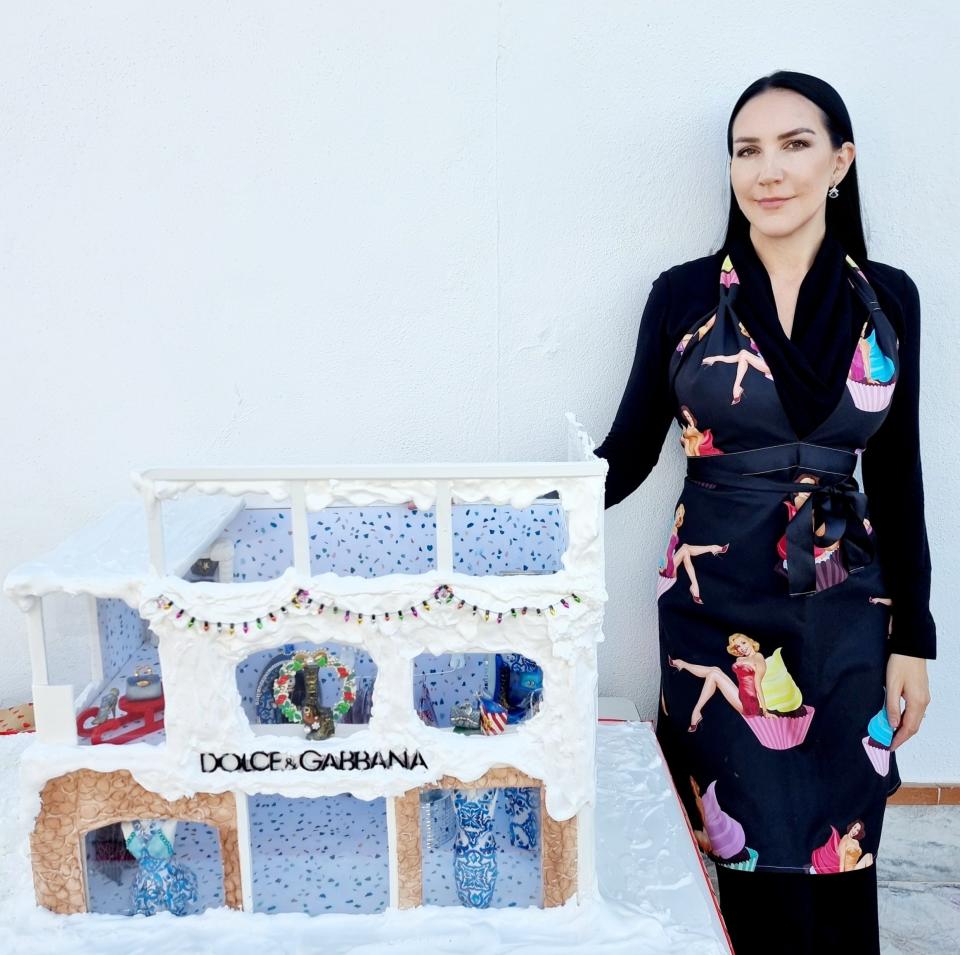 Woman stands next to cake