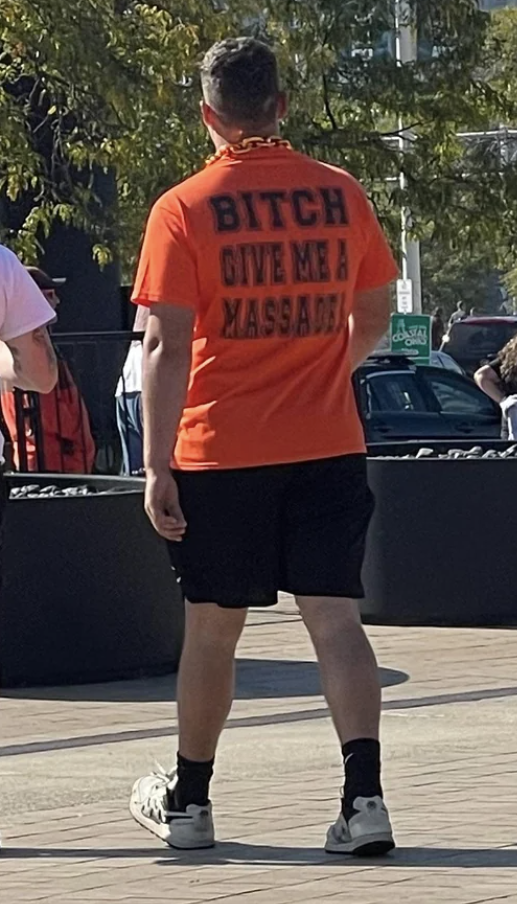 man wearing a shirt that reads, bitch give me a massage