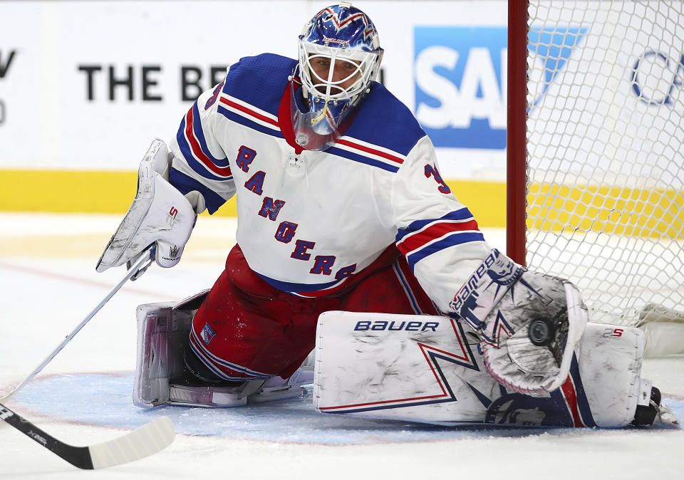 FKILE - In this Oct. 30, 2018, file photo, New York Rangers goalie Henrik Lundqvist makes a save in overtime during an NHL hockey game against the San Jose Sharks, in San Jose, Calif. The New York Rangers have bought out the contract of star goaltender Henrik Lundqvist. The Rangers parted with one of the greatest netminders in franchise history on Wednesday, Sept. 30, 2020, when they paid off the final year of his contract.(AP Photo/Ben Margot, File)