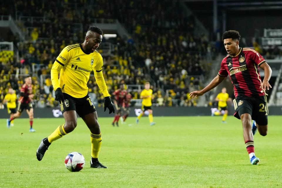 Nov 1, 2023; Columbus, Ohio, USA; Columbus Crew midfielder Kevin Molino (13) movest he ball upfield past Atlanta United defender Caleb Wiley (26) uring the second half of the first round MLS Cup Playoffs matchup at Lower.com Field. The Crew won 2-0.