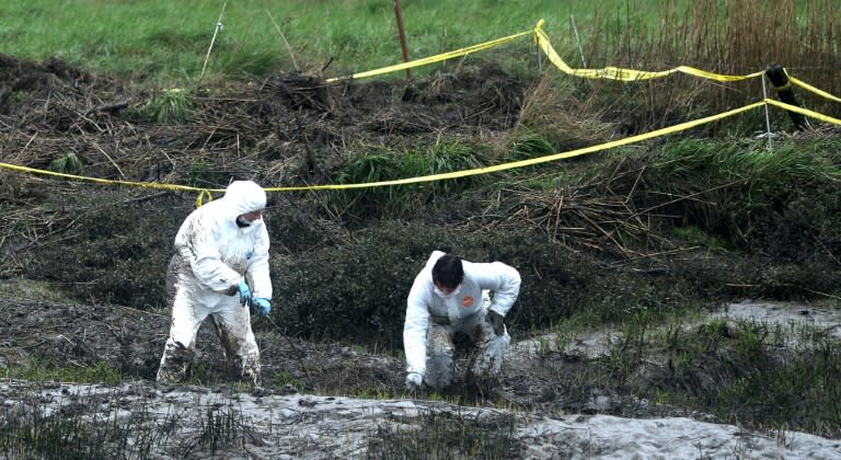 Police officers search March 9, 2017, on the swampy bank of the river Aulne near the Caouissin's house in Pont-de-Buis-lès-Quimerch, western of France