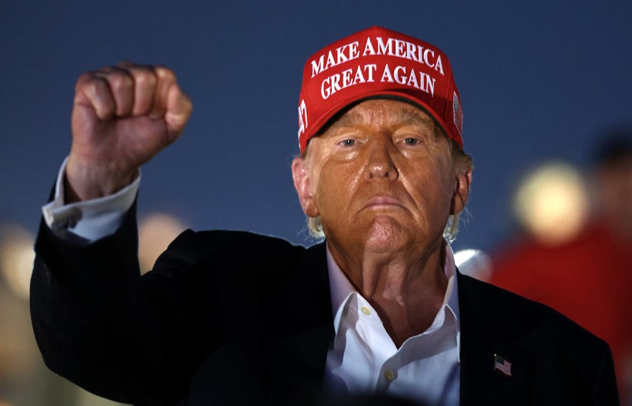 Donald Trump raises his fist during a NASCAR race at Charlotte Motor Speedway on May 26, 2024, in Concord, N.C. <a href="https://www.gettyimages.com/detail/news-photo/former-u-s-president-and-republican-presidential-candidate-news-photo/2154801919" rel="nofollow noopener" target="_blank" data-ylk="slk:Jared C. Tilton/Getty Images;elm:context_link;itc:0;sec:content-canvas" class="link ">Jared C. Tilton/Getty Images</a>