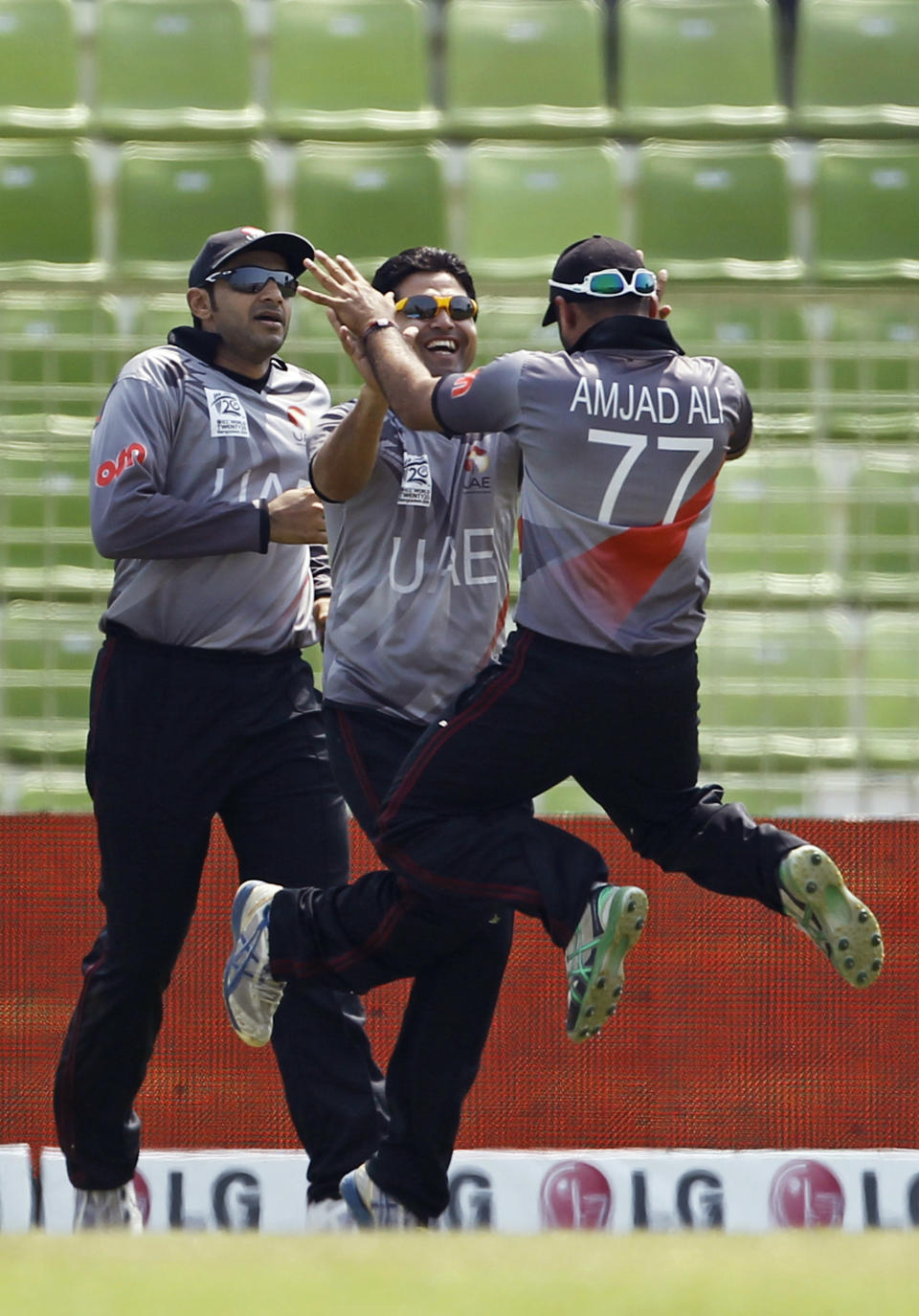 From right, United Arab Emirates' Amjad Ali, Shaiman Anwar, and Faizan Asif celebrate the wicket of Zimbabwe's captain Brendan Taylor during their ICC Twenty20 Cricket World Cup match in Sylhet, Bangladesh, Friday, March 21, 2014. (AP Photo/A.M. Ahad)