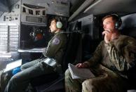 Afghan Air Force pilot and U.S. advisor are seen inside a C-130 military transport plane in Kabul, Afghanistan July 9, 2017. REUTERS/Omar Sobhani