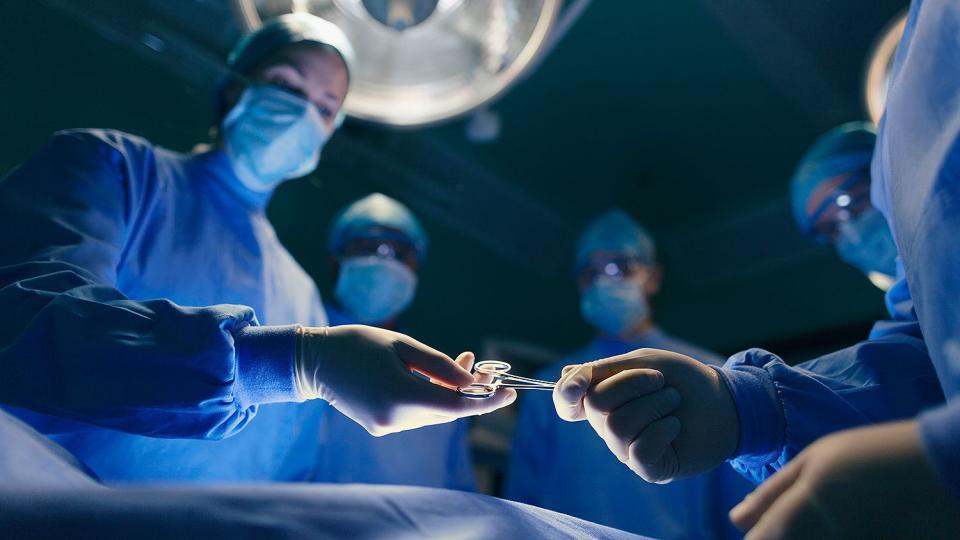 Operating room staff performing hospital surgery