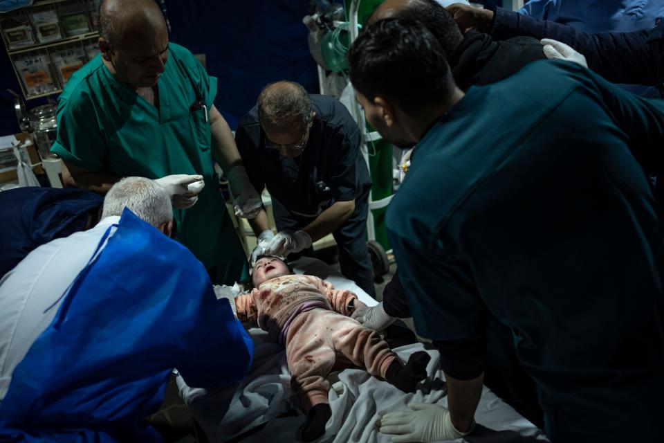 A Palestinian girl wounded in the Israeli bombardment of the Gaza Strip arrives at a hospital in Rafah on Wednesday, Dec.13, 2023.