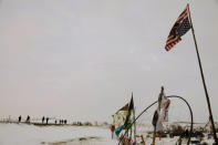 A group walks towards the entrance of the Oceti Sakowin camp as "water protectors" continue demonstrations against plans to pass the Dakota Access pipeline near the Standing Rock Indian Reservation, near Cannon Ball, North Dakota, U.S., December 2, 2016. REUTERS/Lucas Jackson