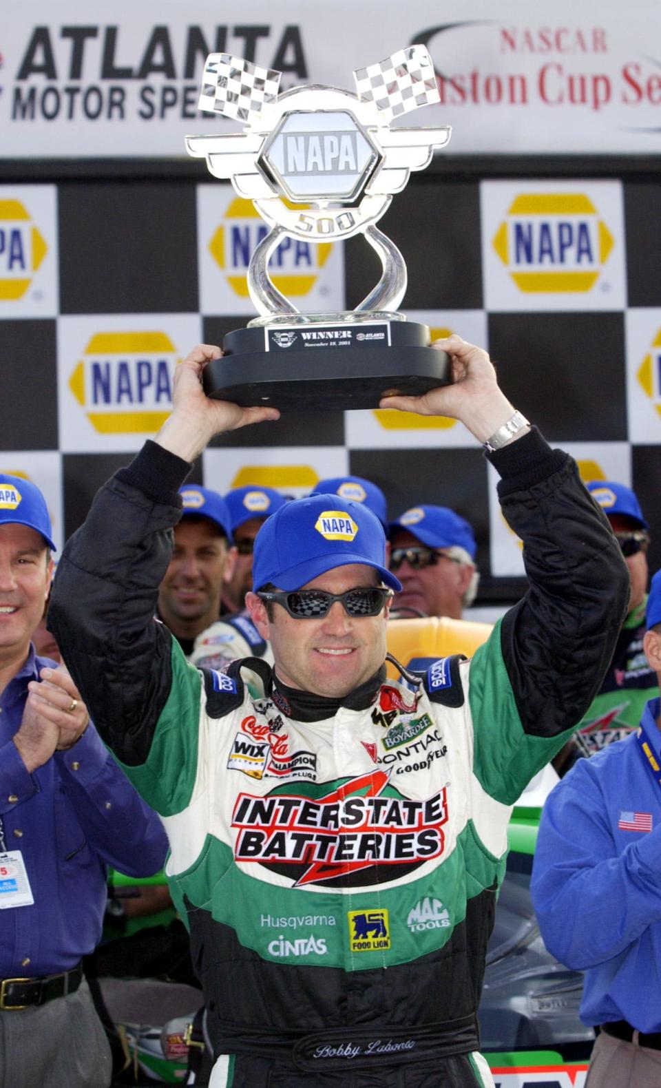 NASCAR driver Bobby Labonte raises the trophy in Victory Lane after winning the NAPA 500 at Atlanta Motor Speedway in Hampton, Ga., Sunday, Nov. 18, 2001. Labonte also won earlier in the season, July 29, 2001, at Pocono.