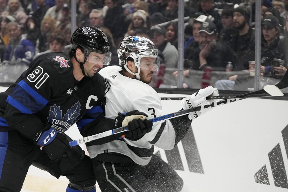 Toronto Maple Leafs center John Tavares, left, and Los Angeles Kings defenseman Matt Roy vie for the puck during the first period of an NHL hockey game Tuesday, Jan. 2, 2024, in Los Angeles. (AP Photo/Mark J. Terrill)