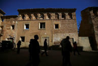 Visitors walk past ruins in the old village of Belchite, in northern Spain, November 14, 2016. REUTERS/Andrea Comas