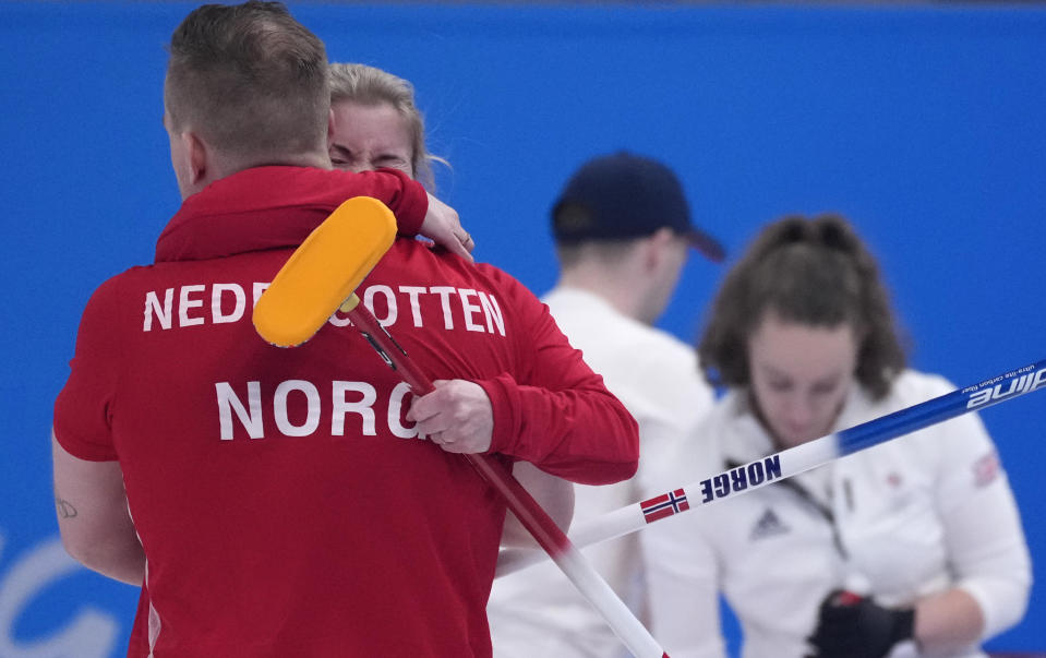 Norway's Magnus Nedregotten and Kristin Skaslien, hug after winning the mixed doubles semi-finals against Britain, at the 2022 Winter Olympics, Monday, Feb. 7, 2022, in Beijing. (AP Photo/Nariman El-Mofty)