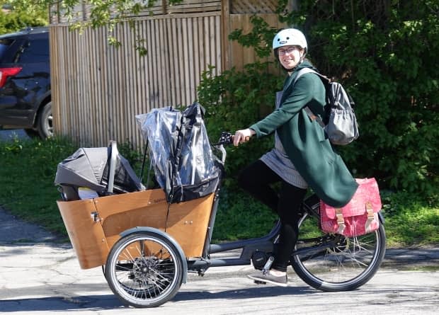 Felicity Borgal recently purchased a power-assisted cargo bike as an alternative to a second car for her family. But it could be banned under new legislation being studied at Queen's Park. (Giacomo Panico/CBC - image credit)