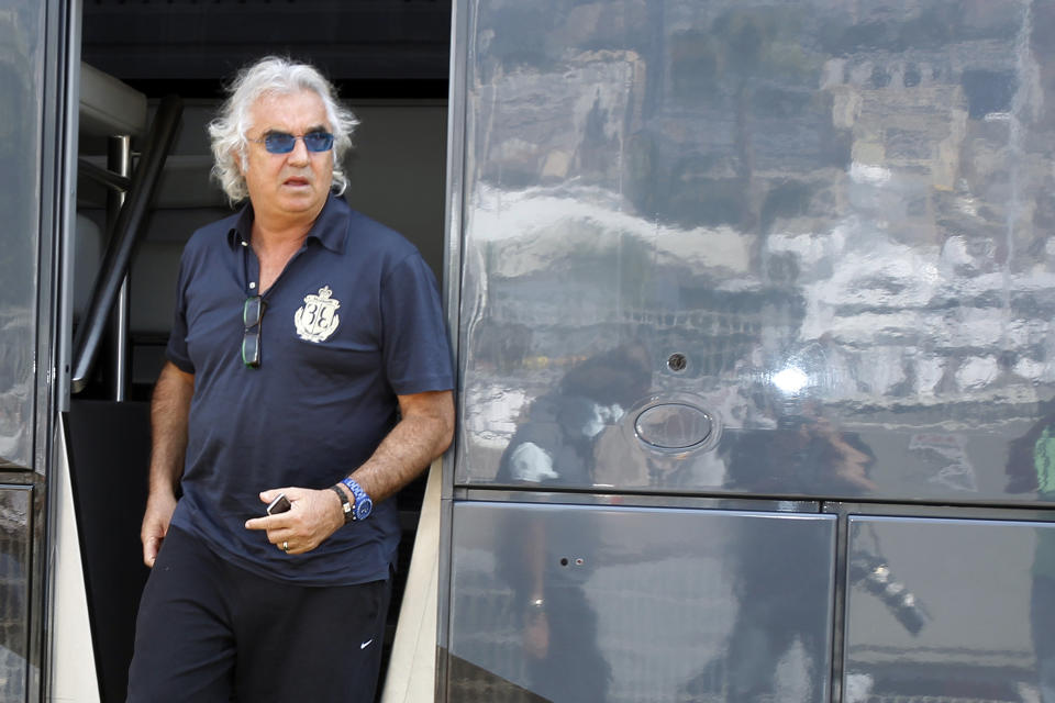 FILE - In this May 14, 2010 file photo, former Renault Team principal Flavio Briatore leaves the FIA motorhome ahead of the Monaco Formula One Grand Prix at the Monaco racetrack, in Monaco. On Tuesday Aug. 25, 2020, Briatore has reportedly been admitted to hospital in Milan with coronavirus, there has been no official statement from the hospital but multiple reports say Briatore’s condition is serious but he is not in intensive care. (AP Photo/Luca Bruno, file)