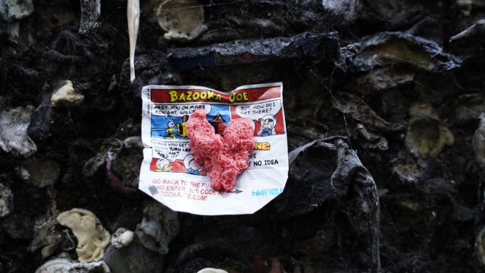 A pink piece of bubblegum holds up a Bazooka comic strip at Bubblegum Alley in San Luis Obispo on Thursday, May 18, 2023.