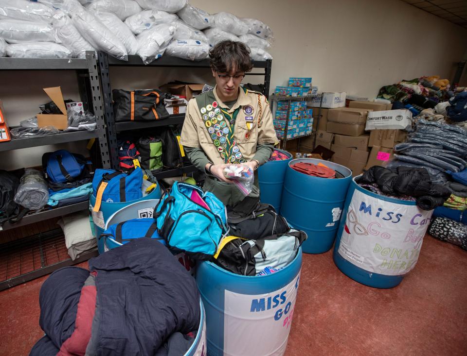 Damian Harms looks through the "go bags" he donated to the Rockford-based nonprofit, Miss Carly's, on Wednesday, Jan. 25, 2023, in Rockford.