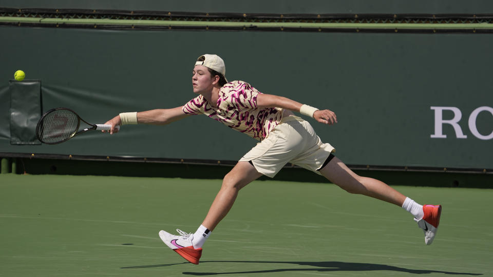 Jagger Leach extends for a shot to Stiles Brockett at the BNP Paribas Open tennis tournament Wednesday, March 15, 2023, in Indian Wells, Calif. Leach is the 15-year-old son of Lindsay Davenport, a three-time major champion and former No. 1-ranked player. (AP Photo/Mark J. Terrill)