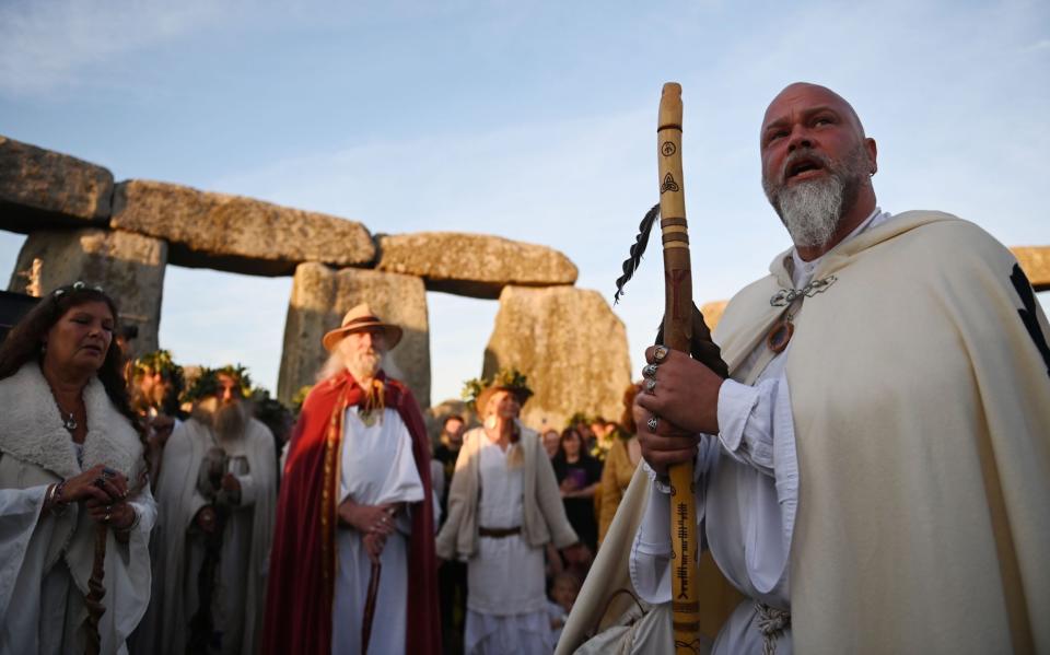 Druids perform a ceremony during summer solstice celebrations at the ancient Stonehenge monument - NEIL HALL/EPA-EFE/Shutterstock