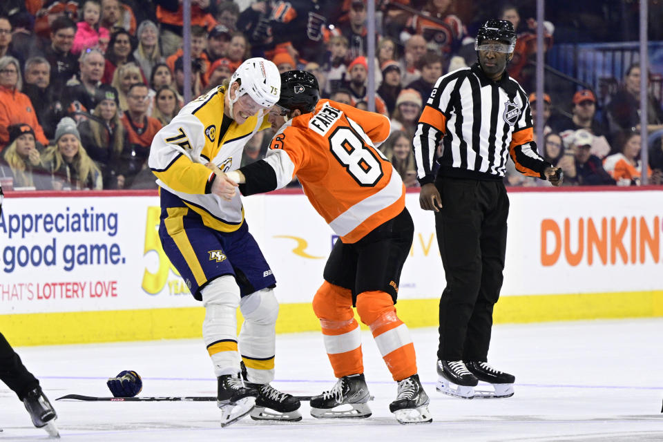 Nashville Predators' Juuso Parssinen, left, and Philadelphia Flyers' Joel Farabee fight as referee Jordan Samuels-Thomas looks on during the second period an NHL hockey game, Saturday, Feb. 11, 2023, in Philadelphia. (AP Photo/Derik Hamilton)