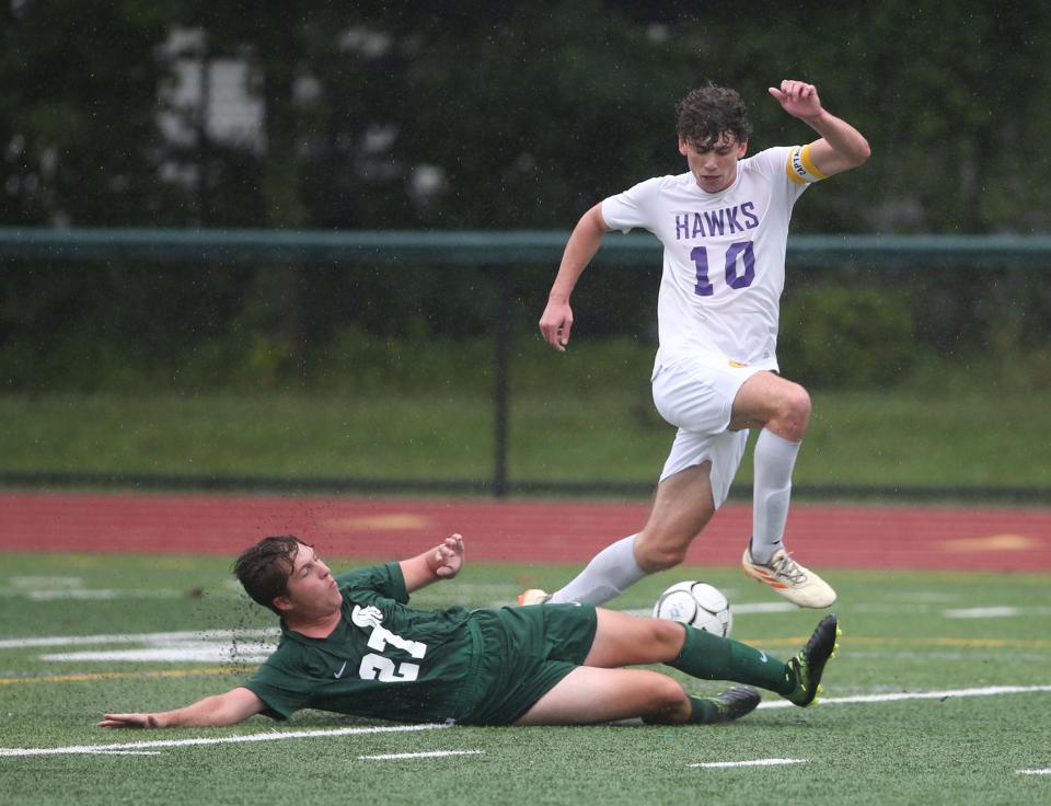 Rhinebeck's Aidan Prezzano (10) leaps over the tackle attempt vs. Spackenkill in September.