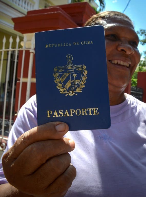 Cruz Duran shows her Cuban passport, in Havana, on October 16, 2012. A law allowing Cubans to travel abroad without special exit visas has taken effect on the communist-ruled island for the first time in half a century