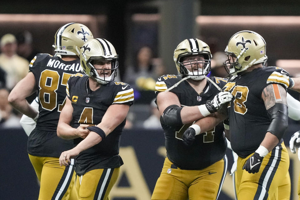 New Orleans Saints quarterback Derek Carr yells at teammate center Erik McCoy during the second half of an NFL football game against the Carolina Panthers in New Orleans, Sunday, Dec. 10, 2023. (AP Photo/Gerald Herbert)